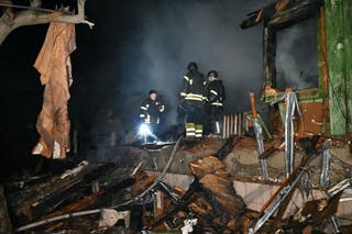 Rescuers inspect the debris of the building after a drone attack in Kharkiv on March 29